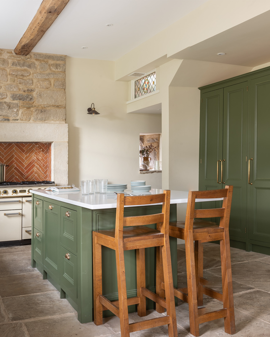 Why green cabinetry and warm brass work